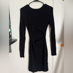 Black. long sleeve. slim fitting dress with a slit in the middle of the stomach